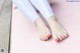 A woman's feet on a pink yoga mat.