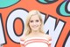 A woman in a red and white striped dress posing for a picture.